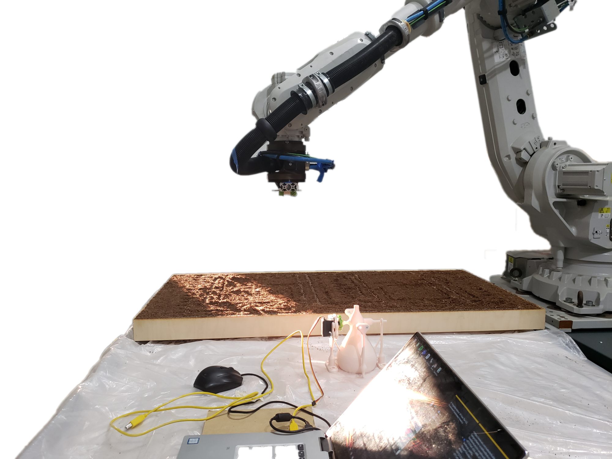Robotic arm seeding a soil bed