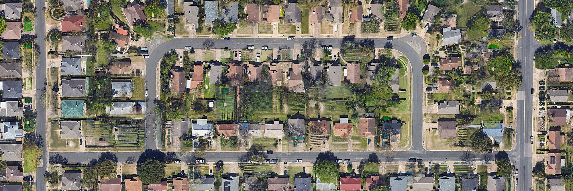 Aerial view of a suburban block with lawns converted to pixel farms
